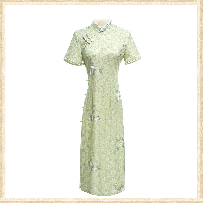 Woman wearing a pastel green modern Cheongsam dress with floral lace embroidery,