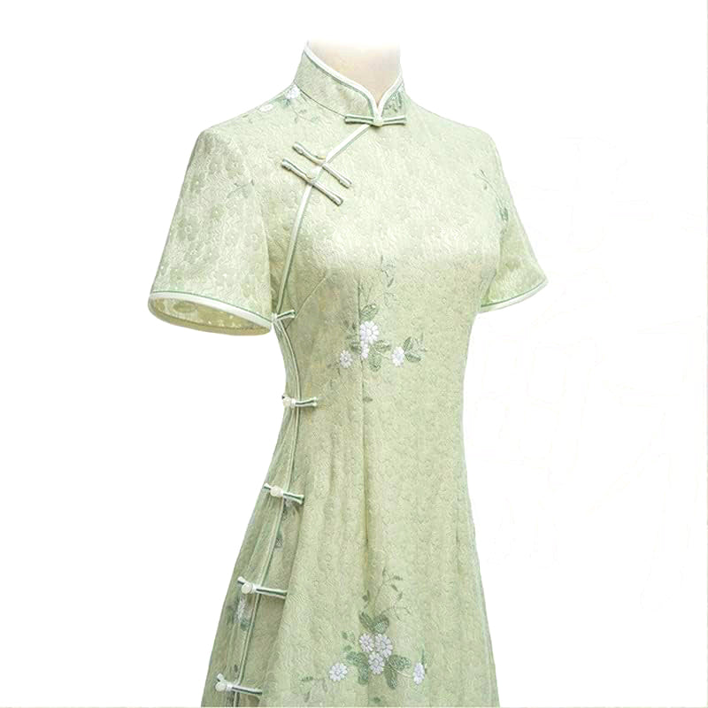Woman wearing a pastel green modern Cheongsam dress with floral lace embroidery,