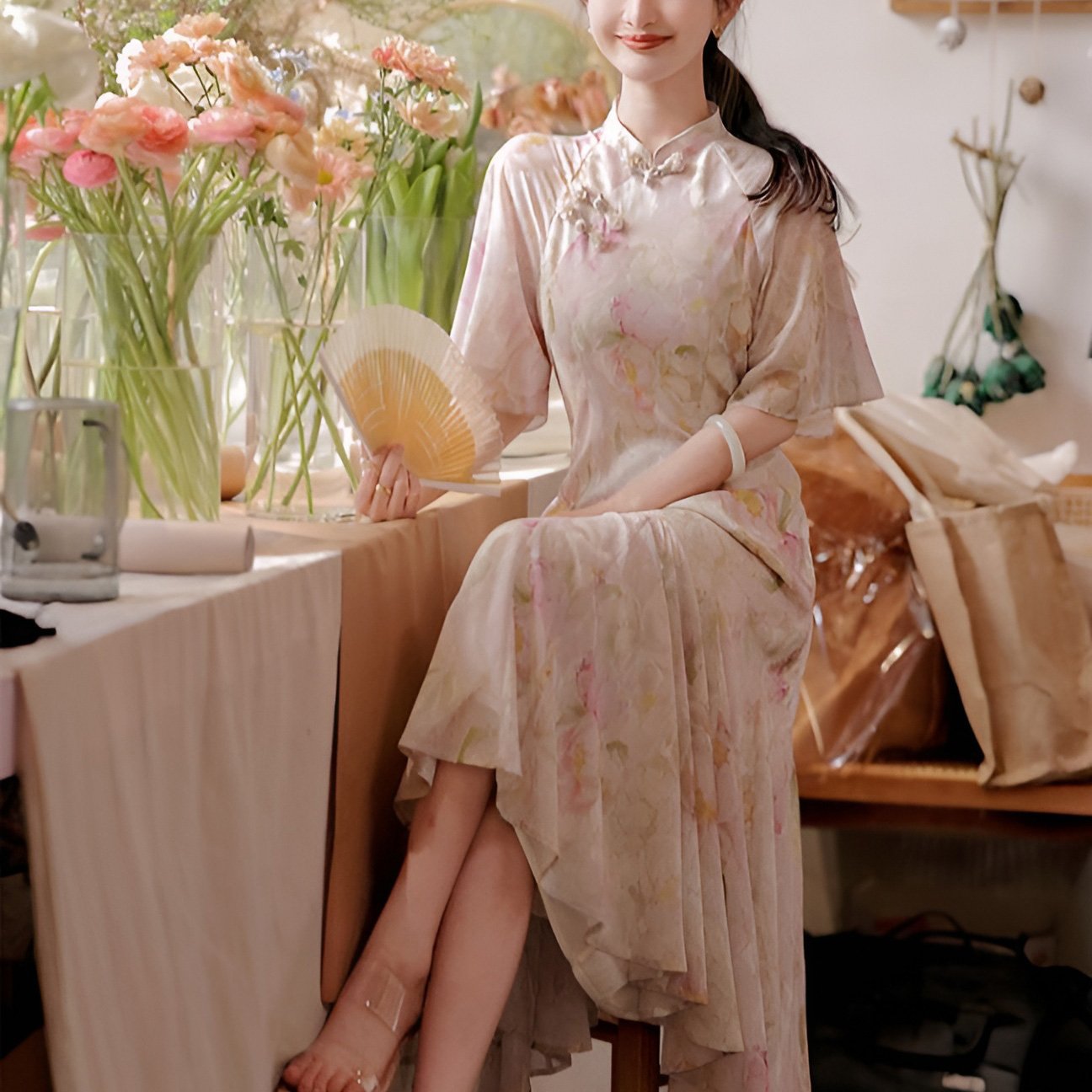 Woman wearing a luxurious modern cheongsam with delicate floral patterns, available in S, M, L.