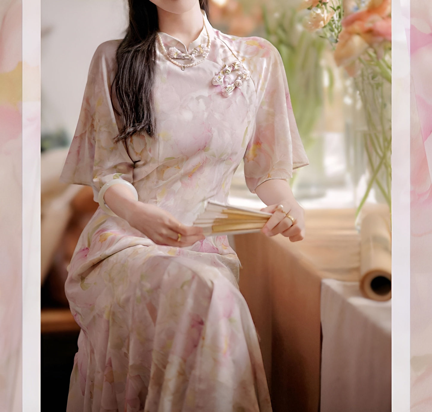 Woman wearing a luxurious modern cheongsam with delicate floral patterns, available in S, M, L.