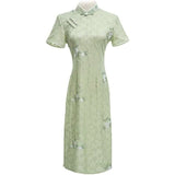 Woman wearing a pastel green modern Cheongsam dress with floral lace embroidery, 